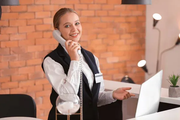 depositphotos_337906990-stock-photo-young-female-receptionist-talking-by